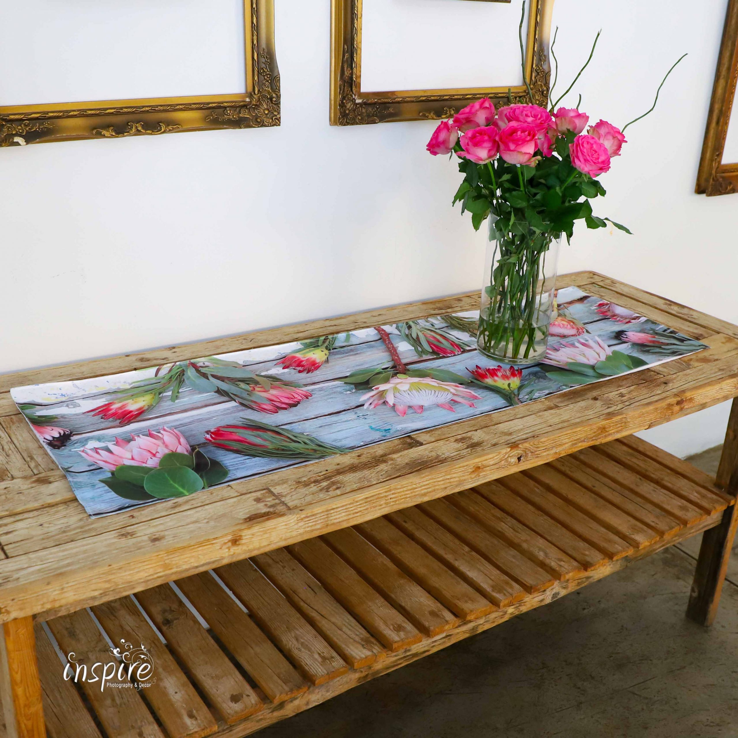 Table runners, protea fabric, satin sheen, table protection, wood, table decor, kombuis, kitchen decor, print, inspire photography and decor, pink proteas on rustic wooden background, dining room table, table cloth, King proteas, pink, green, maroon